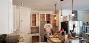 painter-freshens-cabinets